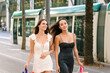 Girlfriends walking on street after shopping
