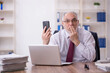 © Elnur - Old male employee and too much work in the office