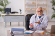 © Elnur - Old male doctor pharmacist in drugs synthesis concept