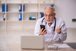 © Elnur - Old male doctor in telemedicine concept