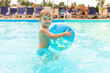 © spyrakot - Kid swim, dive, leisure and playing inflatable ball in pool at vacation