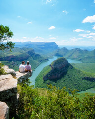 Wall Mural - Panorama Route South Africa, Blyde river canyon with the three rondavels, view of three rondavels and the Blyde river canyon in South Africa. Asian women and Caucasian men on vacation in South Africa