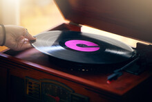 Record Player, Hand And Woman Playing Music In Home Living Room. Classic Technology, Retro And Female Putting Vintage Vinyl Record In Turntable Or Gramophone To Play Sound, Audio Or Song In House.
