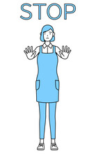 ストップの合図、体の前に手を突き出すエプロンを着た女性