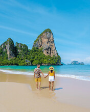Railay Beach Krabi Thailand, The Tropical Beach Of Railay Krabi, A Couple Of Men And Women On The Beach, Panoramic View Of Idyllic Railay Beach In Thailand With A Traditional Long Boat.