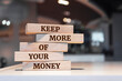 © Uuganbayar - Wooden blocks with words 'Keep More Of Your Money'.