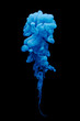 Blue ink swirling in water isolated on black background