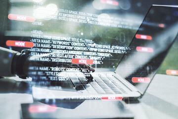 Wall Mural - abstract creative coding concept with hands typing on laptop on background. multiexposure