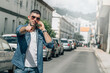 © tetxu - casual man with mobile phone and pointing a street