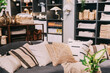 © Great Brut Here - Home accessories and household products in store of shopping centre. View of home accessories for living room in shop fashion retail store. Sofa with pillows. View of assortment of decor for interior