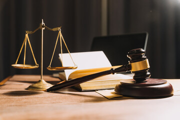 Business and lawyers discussing contract papers with brass scale on desk in office. Law, legal services, advice, justice and law concept picture with film grain effect