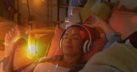 Poster - Animation of sunset landscape over biracial woman listening to music with headphones on