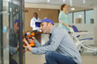 © auremar - man repairing vending machine using screwdriver in hospital