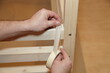 Carpenter glue masking tape on wooden furniture. Home carpentry