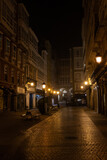 Fototapeta Uliczki - Pedestrian narrow street at night. Lights are on and there are no people, loneliness.