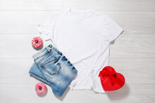 White Tshirt Mockup. Valentines Day Concept Shirt, Gift Box Heart Shape On Wooden Background. Copy Space, Template Blank Front View T-shirt Clothes. Romantic Outfit. Flat Lay Holiday Fashion
