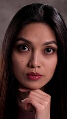 Wall Mural - Portrait of a young beautiful woman against a neutral background - studio shooting