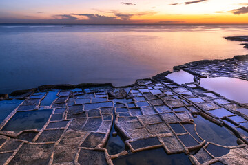 Wall Mural - Marsaskala salt pans and se at sunrise, Malta