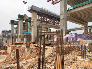 Wall Mural - MELAKA, MALAYSIA -JUNE 19, 2022: A view of a construction site in full swing. Machines and workers are busy doing work. The safety level is ensured to reach the required standards.