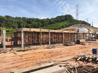 Wall Mural - MELAKA, MALAYSIA -JUNE 19, 2022: A view of a construction site in full swing. Machines and workers are busy doing work. The safety level is ensured to reach the required standards.