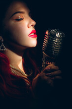 Gorgeous Red Haired Woman Singing With Retro Microphone On The Stage