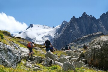 Scenery of Tian Shan Mountains during trekking in Altyn Arashan Valley to beautiful glacier. Silhouette of hiking people. Karakol National Park, Kyrgyzstan, Central Asia