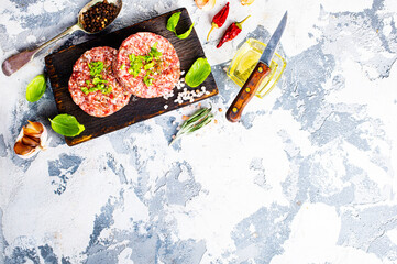 Poster - Billets for burgers from fresh minced meat with spices on a wooden board