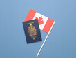 A Canadian passport on a Canadian Flag against a solid light blue background