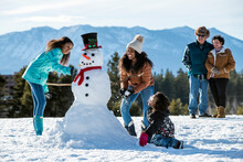 A Family Building A Snowman In Stateline, Nevada.