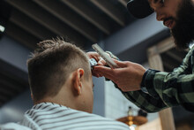 Young Bearded Man Getting His Haircut At The Barber