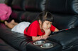 © waranyu - kid is addicted to tablet, little girl playing smartphone, kid use telephone, watching cartoon