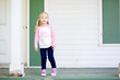 © Cavan Images - Girl on porch looking pensive girl power shirt