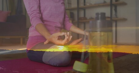 Sticker - Animation of sunset landscape over woman practicing yoga, exercising at home