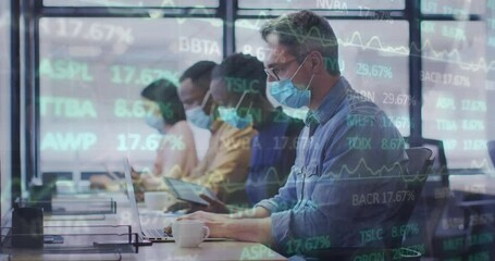 Canvas Print - Animation of trading board over multiracial coworkers working over laptop in office