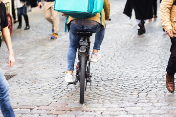 Wall Mural - man riding with bicycle through a crowd of people