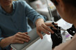 © New Africa - Professional manicurist filing client's nails in beauty salon, closeup