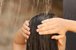 Woman washing hair in outdoor shower on summer day, closeup