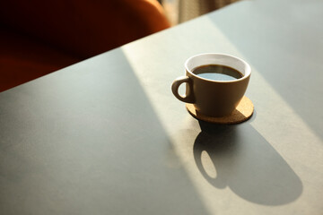 Poster - Cup of delicious coffee on grey table indoors, space for text