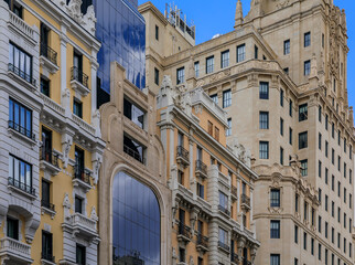 Sticker - Facades of beautiful buildings on Gran Via shopping streets in the center of the city in Madrid, Spain