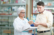 © ijeab - Pharmacist talking to a client about prescribed medications.