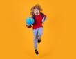 © Olena - Back to school. Full body of primary school kid child boy in casual clothes with backpackand book globe jumping against blue background.