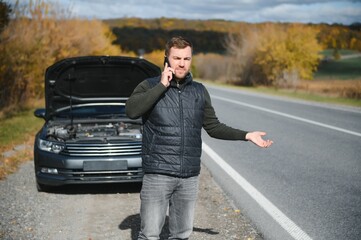 Wall Mural - Man with broken car in the middle of the road.