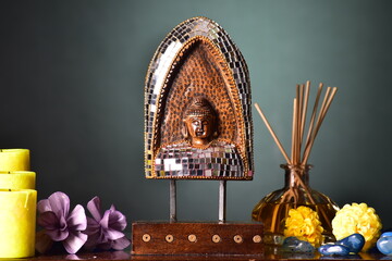 handcrafted wooden statue buddha with reed diffuser spa decor still life concept