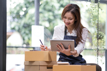 Successful entrepreneur business woman with online sales and Parcel shipping in her home office, prepare parcel box of product for deliver to customer.