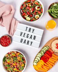 Wall Mural - Vegan or veganuary feast with various salads ad healthy plates on light gray table