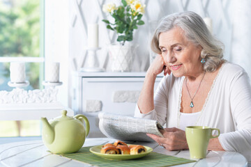 Sticker -  senior beautiful woman reading newspaper at home