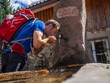 © Cavan Images - Male hiker drinking water from source in Simonswald, Baden-Württemerg, Germany