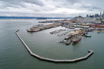 Wall Mural - Aquatic Park Pier , Cove and Municipal Pier in San Francisco. Maritime National Historic Park in Background. Cityscape of San Francisco. California. Drone