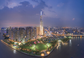 Wall Mural - HOCHIMINH CITY, VIETNAM - JANUARY 8, 2022: Aerial photo evening at District 1, view to landmark 81, see Hanoi highway, Saigon bridge and metro under construction. Nearby is Vinhomes Central Park.