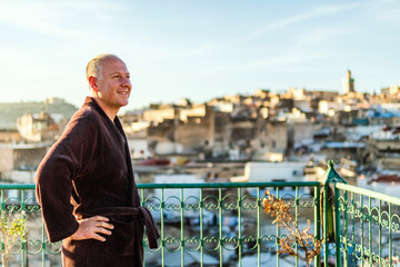 Wall Mural - Man on the rooftop enjoying view of Fez old arabic medina, Morocco, Africa